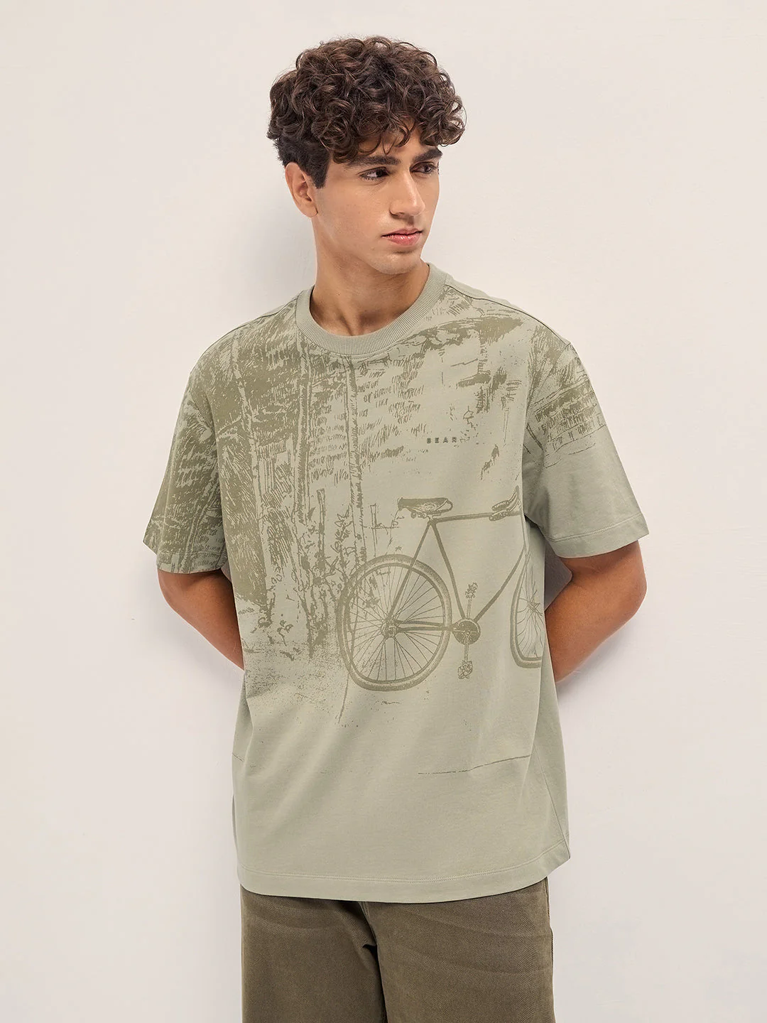 Beige Crew Neck T-Shirt with Abstract Bicycle Graphic Print